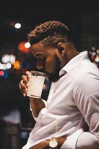 a man drinking a glass of water